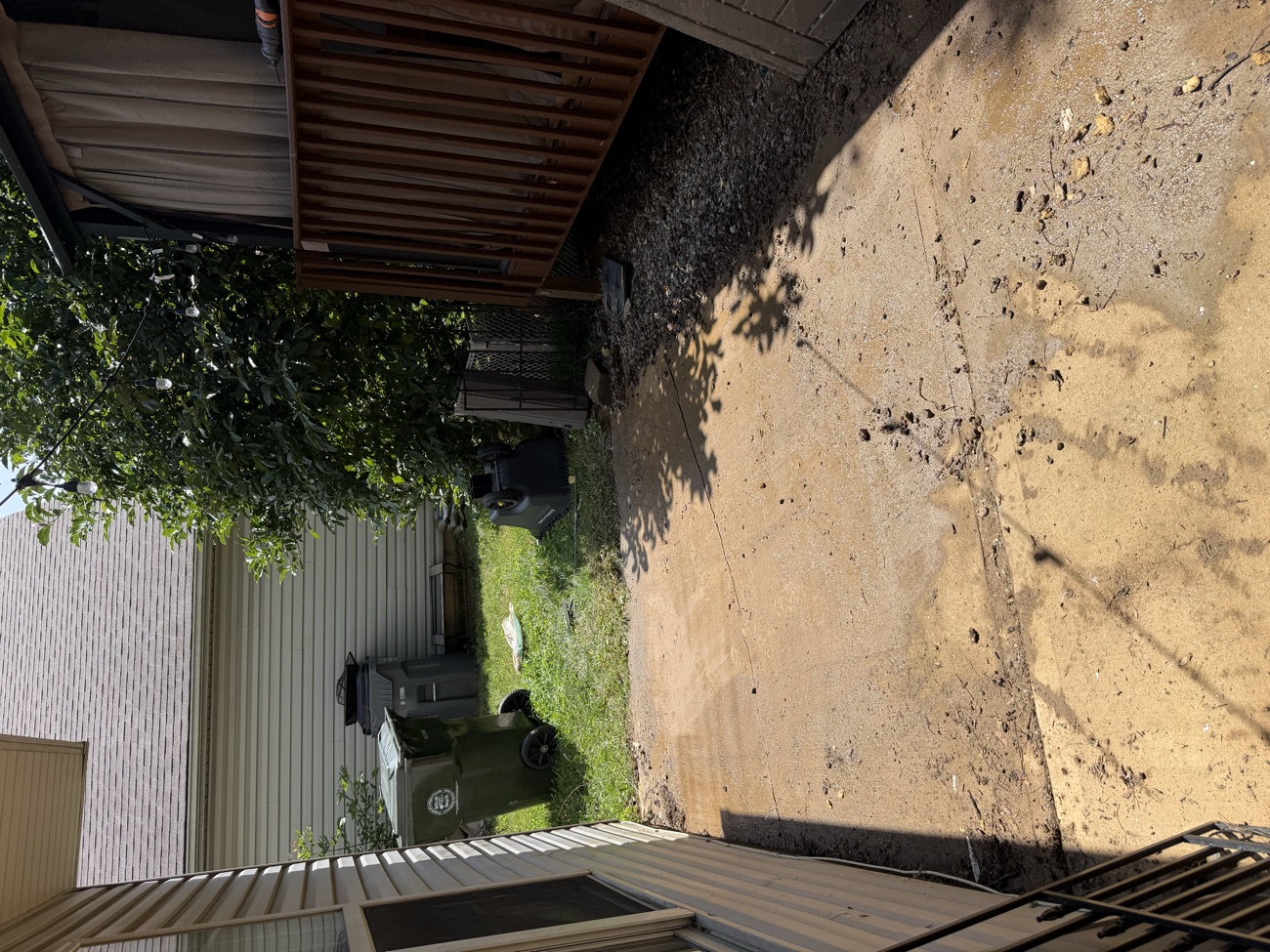 The concrete pad cleared out and swept clean after the debris was hauled away.