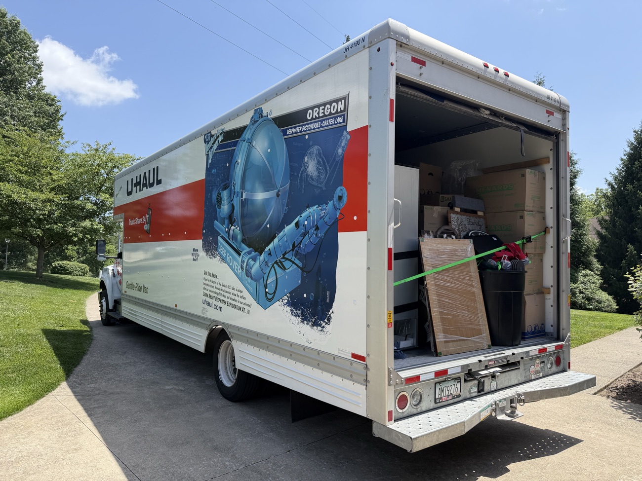 A moving truck loaded with furniture and boxes hauled away on a job.