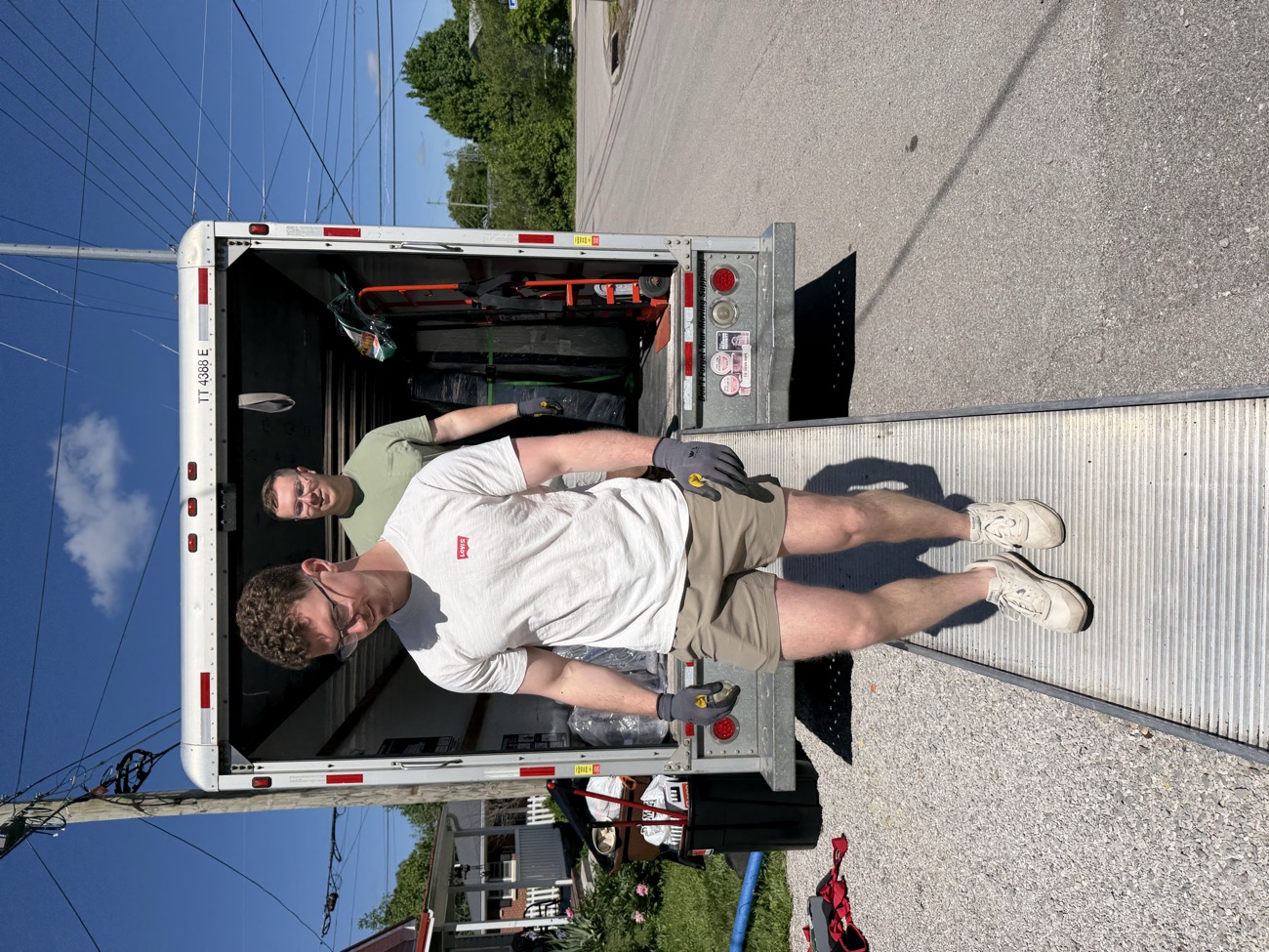 The New Creation Cleanup crew carrying items down the box truck ramp.