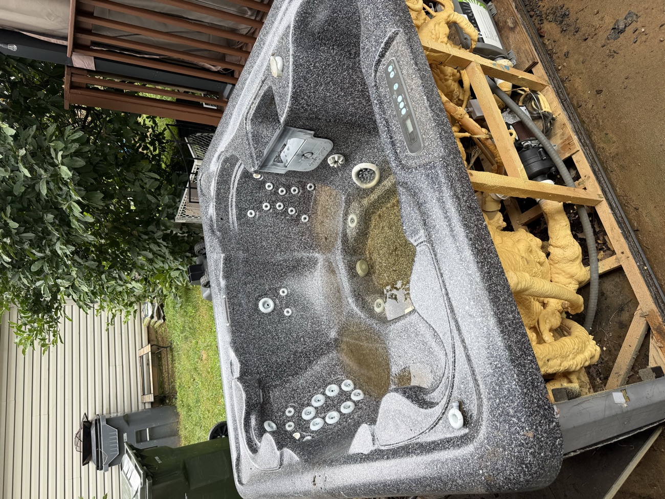 An old hot tub loaded onto the truck for heavy item removal.