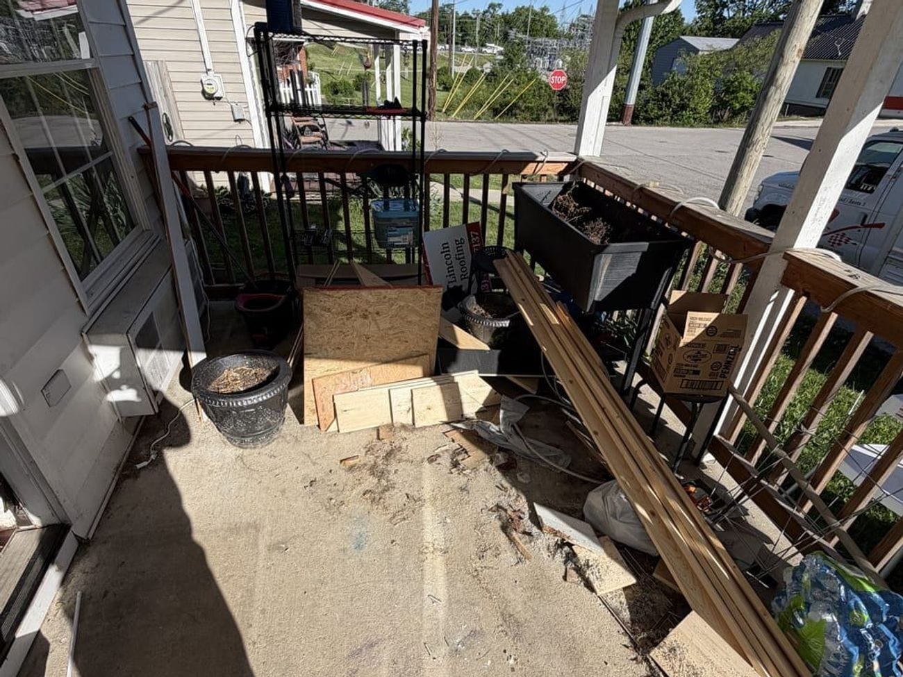 The same front porch with the totes and clutter hauled off and the concrete swept down.